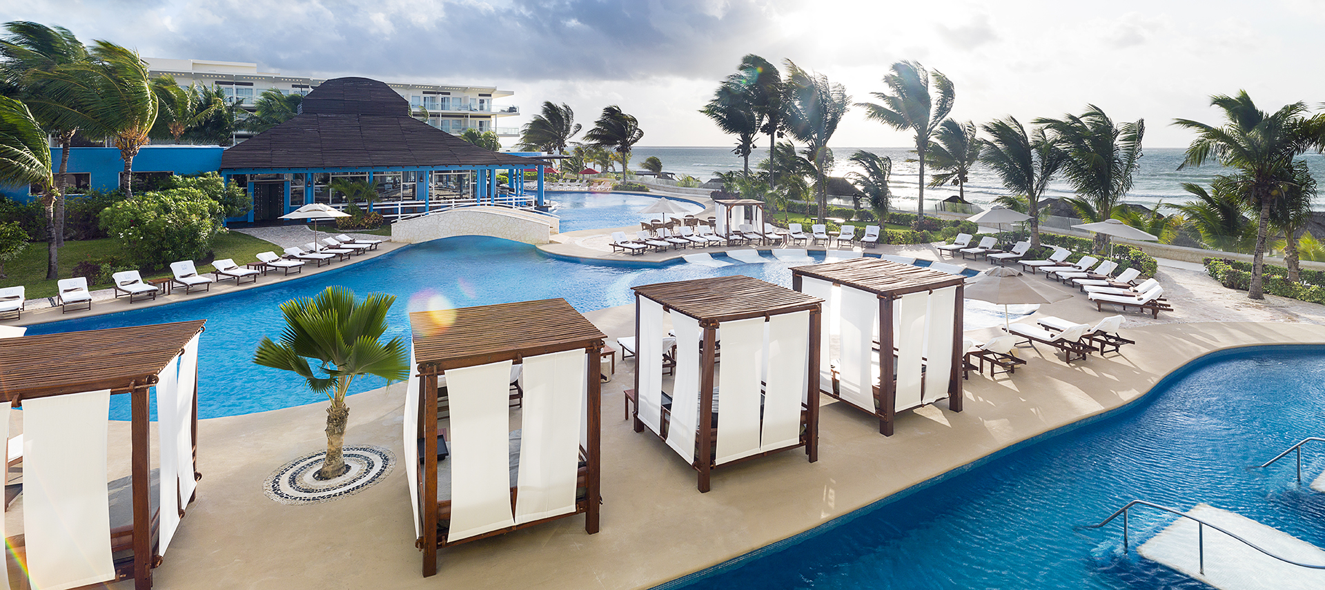 Cabanas surrounding pools at azul beach resort riviera cancun
